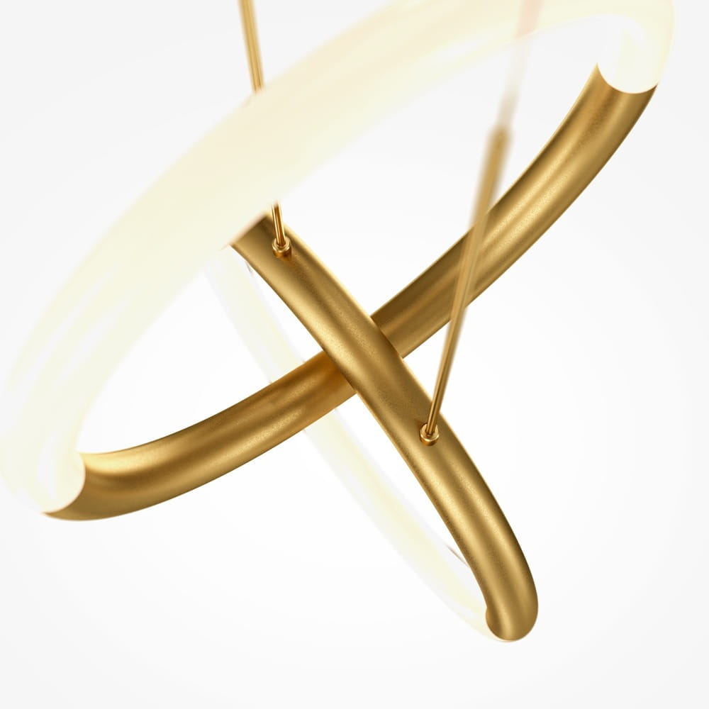 Złota lampa wisząca LED Node z dwoma punktami świetlnymi, o nowoczesnym, okrągłym kształcie. Wykonana z metalowych elementów o matowej fakturze, z białymi akcentami świetlnymi. Widok z góry, prezentujący skrzyżowane ramiona lampy na jasnym tle.