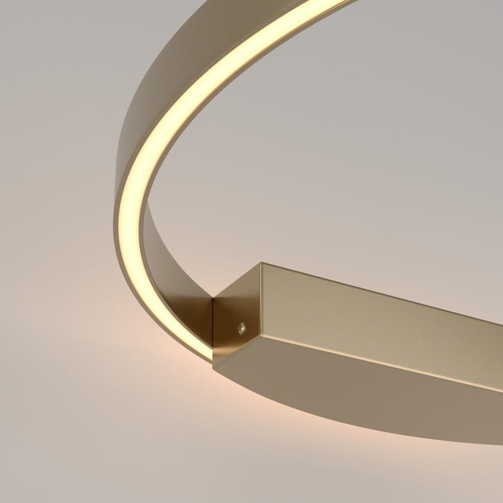 Kinkiet Rim D60 LED w kolorze mosiądzu z okrągłą oprawą i wbudowanym źródłem światła. Ujęcie z boku, ukazujące gładką, metaliczną powierzchnię oraz delikatne podświetlenie krawędzi. Prosty, nowoczesny design, idealny do aranżacji wnętrz.