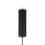 Czarna, wisząca lampa LED Supersymmetry, cylindryczny kształt, matowa faktura. Zawieszona na cienkim kabelku, widok z dołu. Prosty design, idealna do nowoczesnych wnętrz.