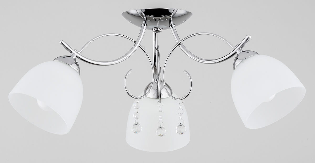 Lampa sufitowa Otelia 3-punktowa w kolorze chromu z trzema matowymi kloszami. Klosze mają kształt lekko rozchylający się ku dołowi, ozdobione kryształowymi detalami. Montaż na suficie, widok z dołu.