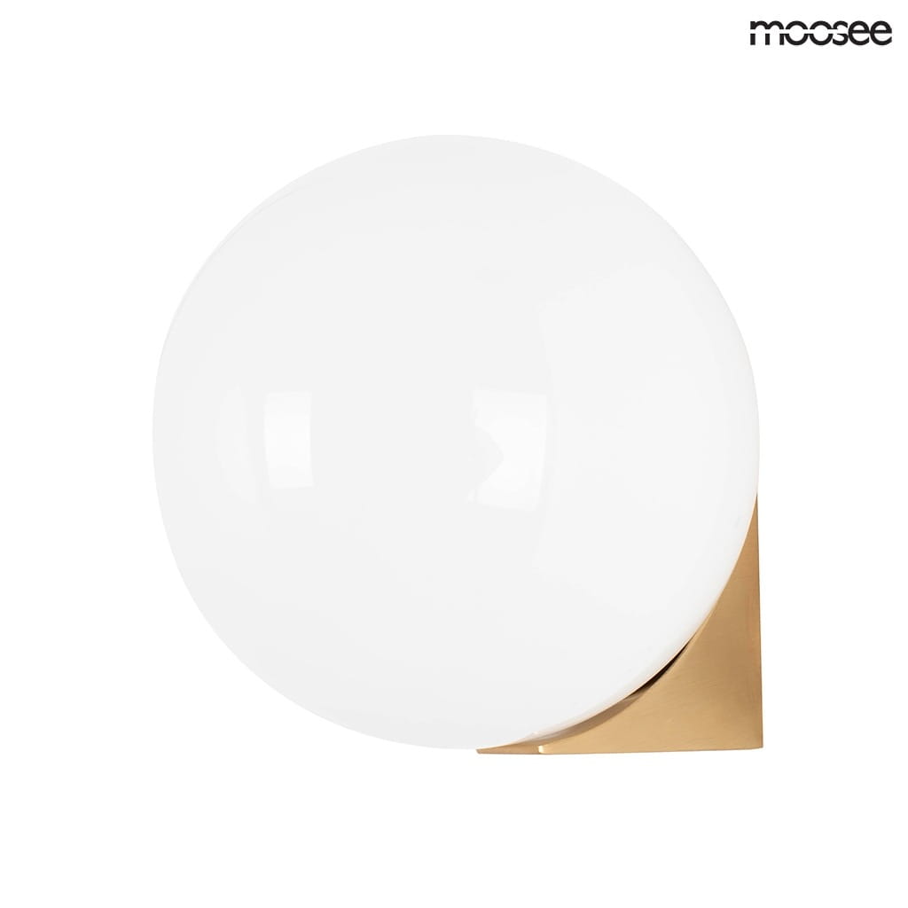 Kinkiet Boll 1-punktowy w złotej oprawie, z białą, okrągłą kula lampy. Lampa zamontowana na ścianie, widoczna z boku, z minimalistycznym designem. Złote mocowanie kontrastuje z gładką, błyszczącą powierzchnią szkła.