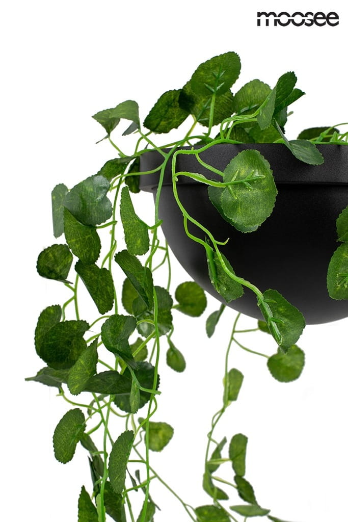 Czarny kinkiet LED Plant Wall z jednopunktowym mocowaniem. Widzoczna doniczka z sztucznymi zielonymi pnączami, zwisającymi z krawędzi. Rośliny mają różne kształty liści, a całość prezentuje nowoczesny design. Tło białe.