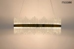 Lampa wisząca Florens 80 LED w kolorze złotym, o nowoczesnym designie. Produkt ma formę długiego, prostokątnego klosza z przezroczystymi elementami, które tworzą efekt świetlny. Zawieszona na cienkich linkach, idealna do nowoczesnych wnętrz.
