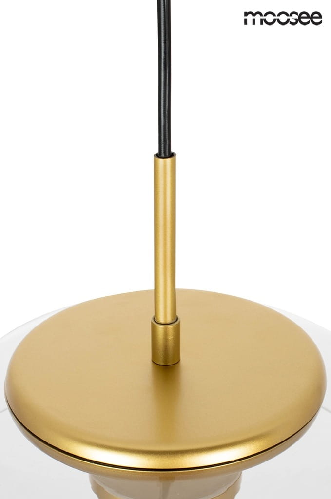 Złota lampa wisząca Eden LED z pojedynczym punktem świetlnym. Widoczny okrągły, metaliczny zwis z gładką powierzchnią oraz czarnym przewodem. Lampa ma minimalistyczny design, idealna do nowoczesnych wnętrz.