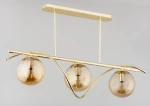 Lampa wisząca Varna 3-punktowa w kolorze złotym, z trzema okrągłymi kloszami w odcieniu bursztynowym. Elementy metalowe o gładkiej fakturze, zawieszone na minimalistycznej, łukowatej konstrukcji. Prosta, elegancka forma.