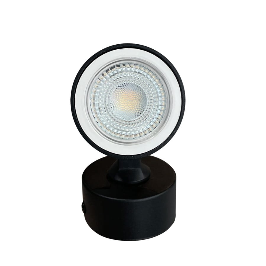 Lampa sufitowa Anillo w kolorze czarnym, z pojedynczym spotem GU10. Okrągła głowica z przezroczystym kloszem, zamontowana na cylindrycznym uchwycie. Zbliżenie na detal lampy, stojąca na gładkiej powierzchni.