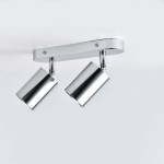 Lampa sufitowa Belize z dwoma reflektorami GU10 w chromowanej obudowie. Reflektory mają cylindryczny kształt i są zamontowane na prostokątnej podstawie. Ujęcie z przodu, na jednolitym tle.