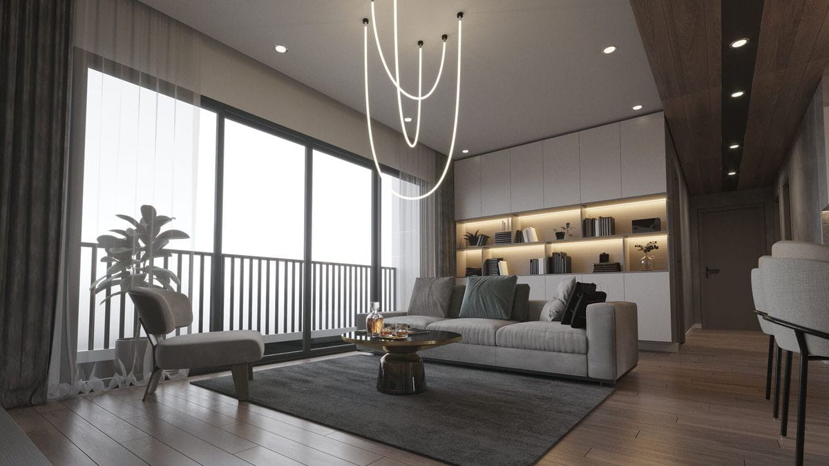Lampa wisząca Rope Light 1xLED/50W w kolorze złotym, zawieszona w nowoczesnym wnętrzu. Kształt przypominający wstążki, z trzema pętlami. Otoczenie to przestronny salon z sofą, stolikiem kawowym i dużymi oknami.