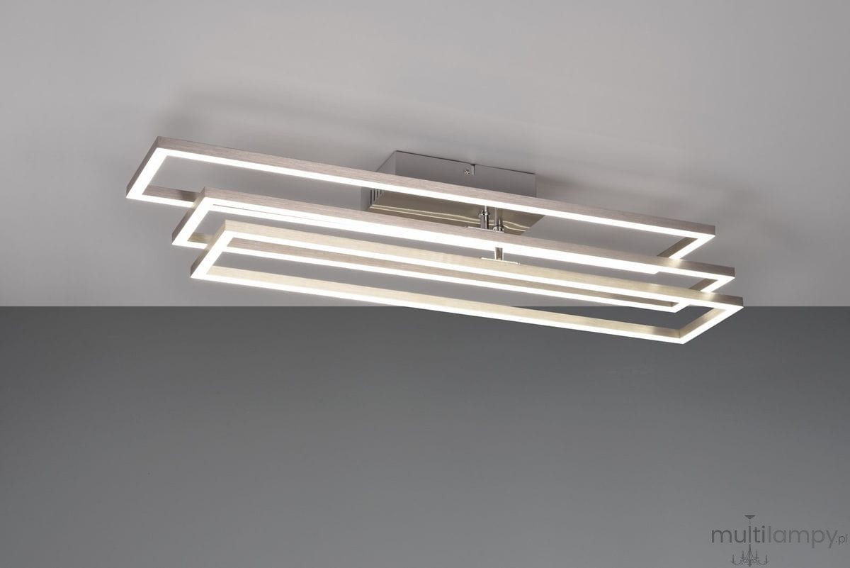 Lampa sufitowa Corso z pilotem, 3xLED/36W, wykonana z niklu. Posiada trzy prostokątne ramy w formie poziomych poziomych pasków, emitujących ciepłe światło. Zamontowana na metalowej podstawie, umieszczona w centralnej części sufitu.