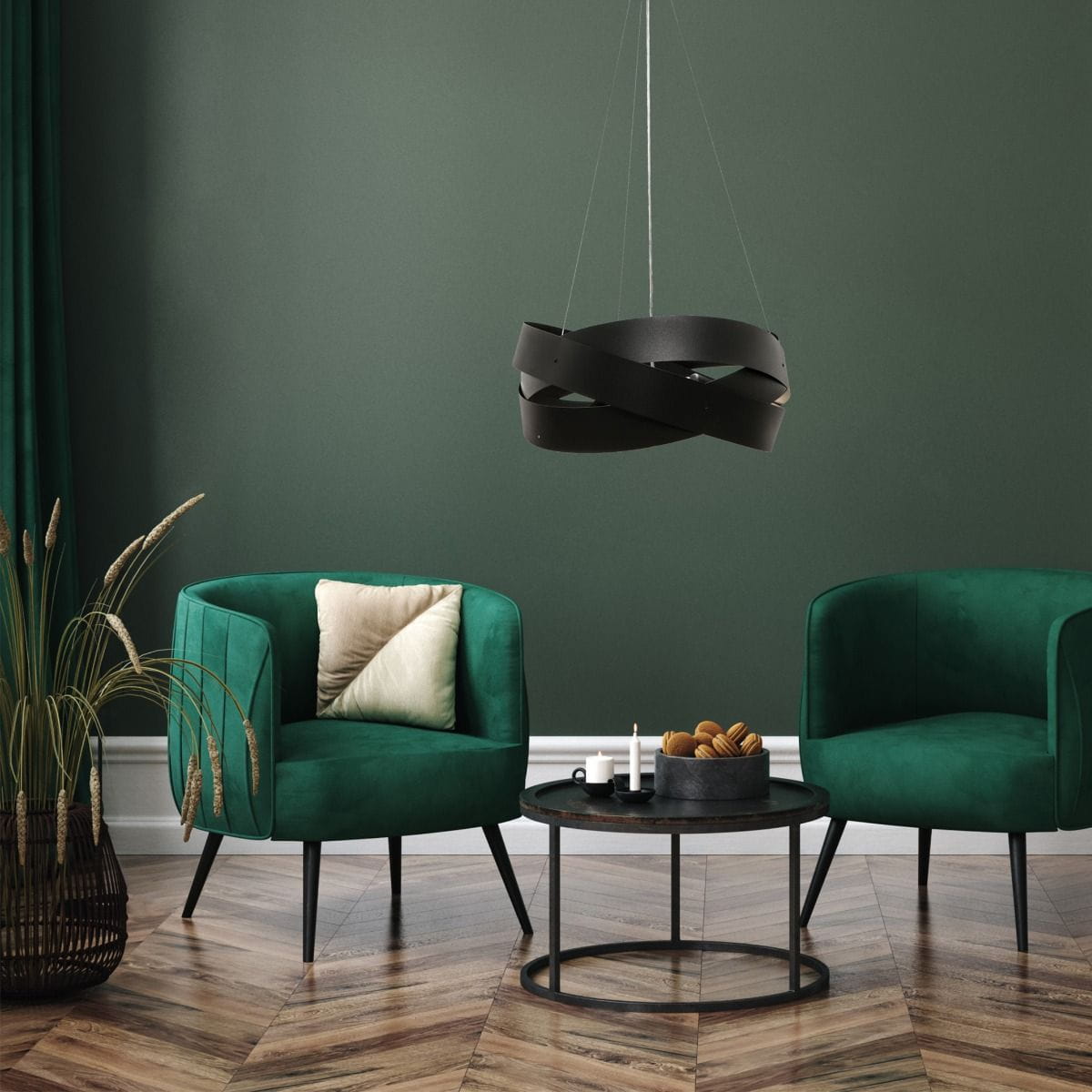 Lampa wisząca Tornado w kolorze czarnym, z trzema gniazdami E27, o nowoczesnym, spiralnym kształcie. Zawieszona na cienkich żyłkach, w aranżacji z zielonymi fotelami i niskim stolikiem na tle ciemnozielonej ściany.