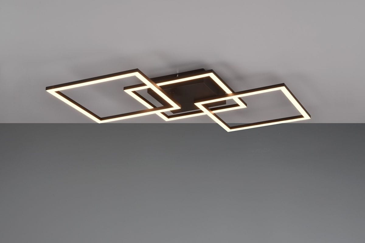 Czarna lampa sufitowa Trail z trzema kwadratowymi ramkami LED, zawieszona w unikalnym układzie. Lampa z matowym wykończeniem, w zestawieniu z jasnym podświetleniem, montowana do sufitu. Tło w odcieniu szaro-srebrnym.