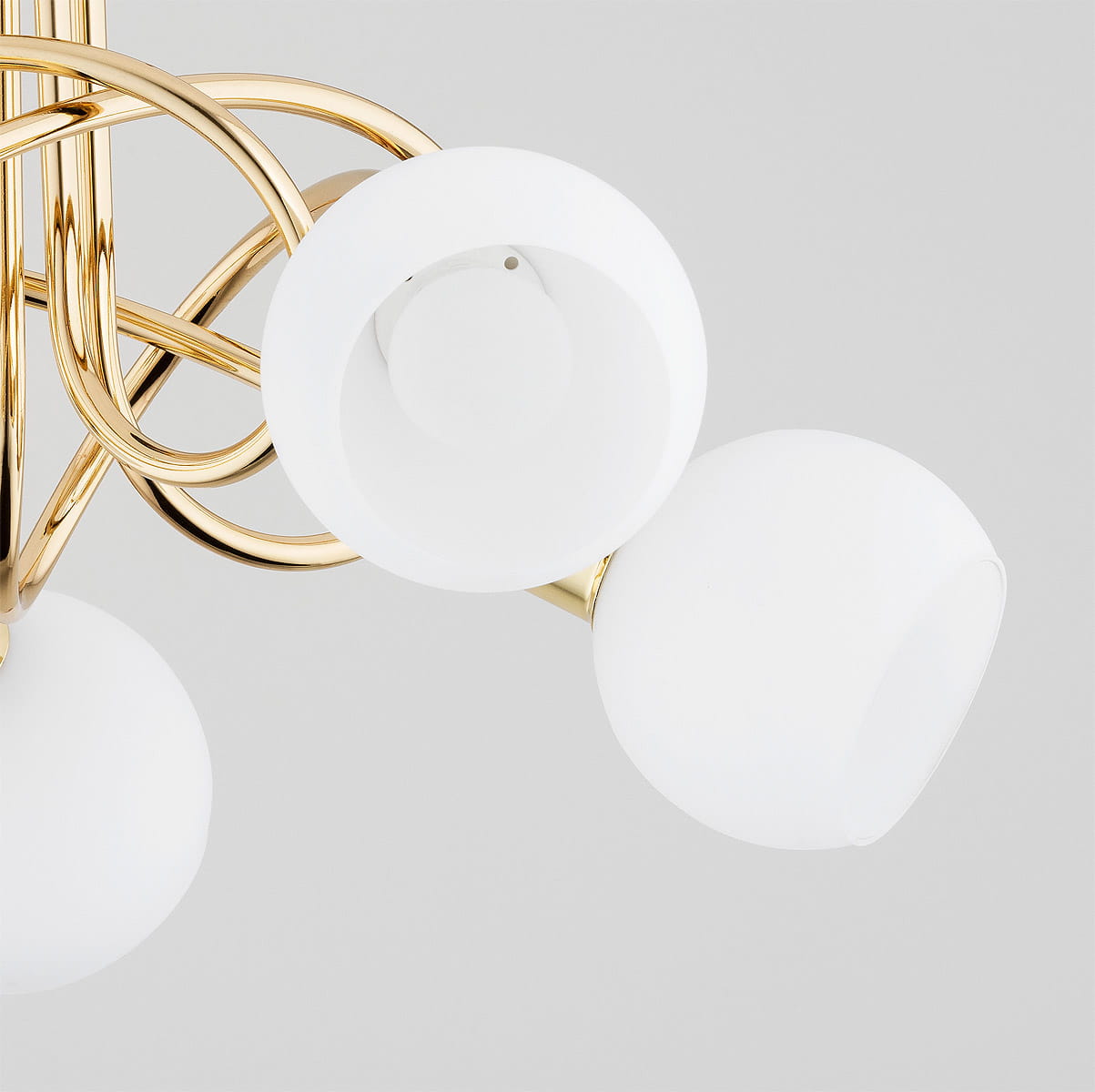 Lampa wisząca Eryka z pięcioma kulistymi kloszami z matowego szkła na złotej, metalowej konstrukcji. Widok z góry, ukazujący eleganckie połączenie kształtów. Idealna do nowoczesnych wnętrz.