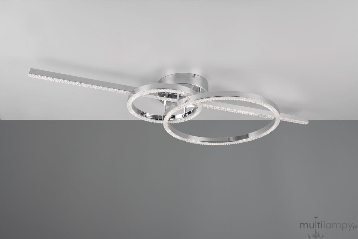 Lampa sufitowa Montilla w kolorze chromu z trzema diodami LED o mocy 54W. Posiada dwa okręgi, z których jeden jest podświetlony. Ujęcie z góry, montowana na suficie, na jednolitym tle. Wbudowany pilot do sterowania.