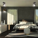 Czarna lampa sufitowa typu spot z jednym miejscem na żarówkę GU10 AR111, zamontowana na suficie w nowoczesnej sypialni. Oświetlenie skierowane w dół, otoczone jasnymi zasłonami i minimalistycznym wystrojem.