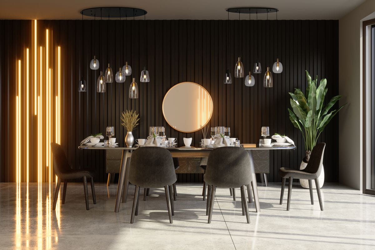 Lampa wisząca Divine z sześcioma żarówkami E14, w kolorze czarnym i multikolorowym, zawieszona w nowoczesnej aranżacji. W tle widoczne drewniane panele, okrągłe lustro oraz stół z zastawą, otoczony krzesłami.