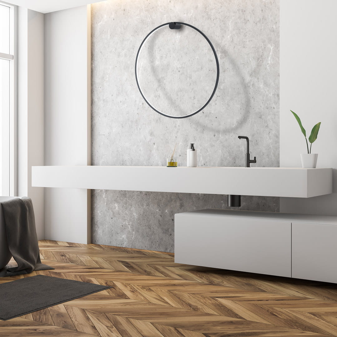 Kinkiet Saturno D80 w kolorze czarnym, z jedną diodą LED o mocy 46W, zamontowany na ścianie. Produkt prezentuje nowoczesny design, idealny do wnętrz. Tło stanowi minimalistyczna aranżacja z betonową ścianą i białymi meblami.