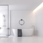 Czarna lampa sufitowa Saturno D50 z jedną diodą LED o mocy 25W, klasyfikowana IP44, zawieszona w nowoczesnej łazience. Oświetlenie w minimalistycznym wnętrzu z białymi kaflami i wanną.
