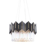 Lampa wisząca Rotta z sześcioma gniazdami E14, w kolorze złotym i czarnym. Okrągła konstrukcja z asymetrycznymi, błyszczącymi elementami oraz przezroczystymi kryształowymi detalami, zawieszona na cienkim przewodzie.