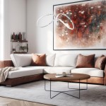 Lampa wisząca Tesoro LED 1-punktowa w chromowanym wykończeniu. Posiada nowoczesny, minimalistyczny kształt z dwoma zakrzywionymi elementami, zawieszona w jasnym wnętrzu nad okrągłym stolikiem. Tło z abstrakcyjnym obrazem i sofą w odcieniach bieli i brązu.