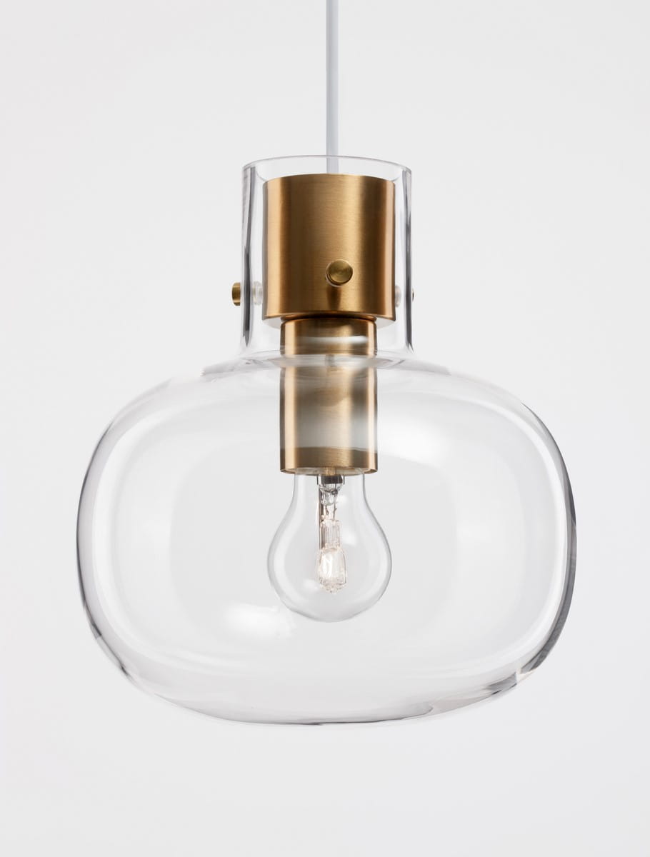 Lampa wisząca Padre z pojedynczym gniazdem E27, złota oprawa metalowa z przezroczystym kloszem o zaokrąglonym kształcie. Widoczna żarówka w środku, zawieszona na białym przewodzie. Tło jasne, jednolite.