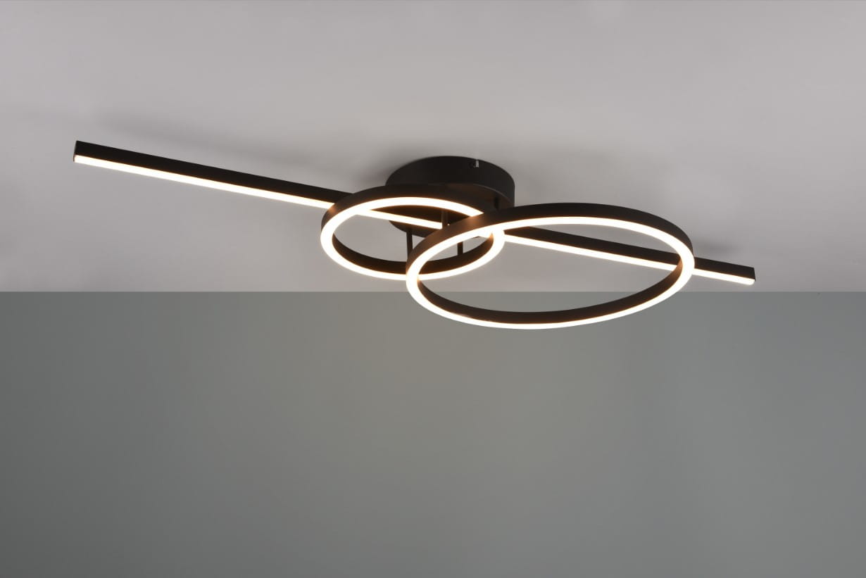 Czarna lampa sufitowa Montilla z pilotem, o trzech źródłach LED (54W). Posiada dwa okręgi oraz poziomą belkę, zamontowana na suficie. Wykończenie matowe, z delikatnym światłem emitowanym przez LED. Idealna do nowoczesnych wnętrz.