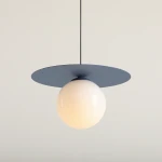 Lampa wisząca Loop Dusty Blue S z niebieskim, okrągłym daszkiem i białą, szklana kulą. Produkt zawieszony na cienkim kablu, w neutralnym otoczeniu. Kształt minimalistyczny, idealna do nowoczesnych wnętrz.