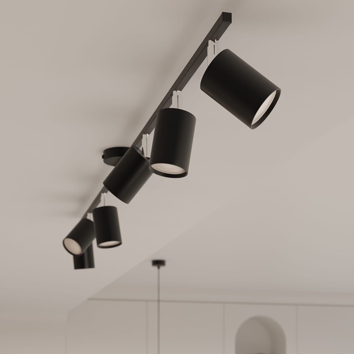 Lemmi lampa sufitowa (spot) z sześcioma czarnymi oprawami GU10, zamontowana na długim, prostokątnym stelażu. Oprawy mają cylindryczny kształt i są skierowane w różne strony, na tle jasnego sufitu.