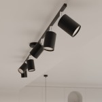 Lemmi lampa sufitowa (spot) z sześcioma czarnymi oprawami GU10, zamontowana na długim, prostokątnym stelażu. Oprawy mają cylindryczny kształt i są skierowane w różne strony, na tle jasnego sufitu.