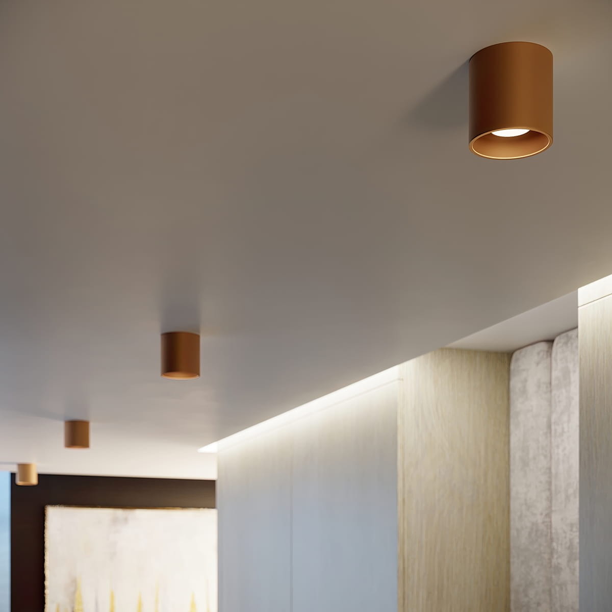 Lampa sufitowa Orbis 1xGU10 w kolorze złotym, w kształcie cylindrycznym, zamontowana na jasnym suficie. Widoczne kilka lamp w równych odstępach, o minimalistycznym designie, pasująca do nowoczesnych wnętrz.