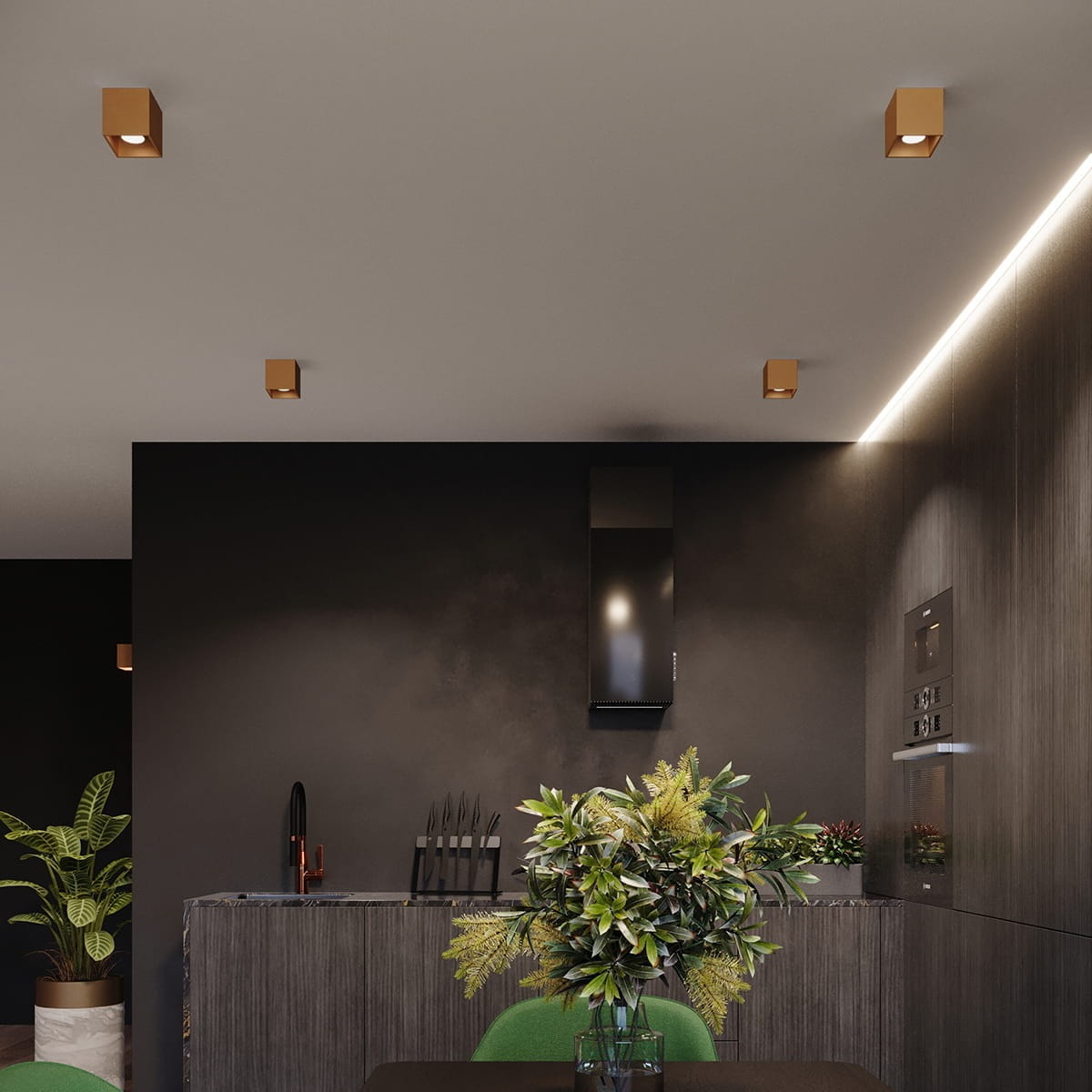 Lampa sufitowa Quad 1xGU10 w kolorze złotym, kwadratowa, zamontowana na sufit. W tle widoczna nowoczesna kuchnia z ciemnymi ścianami, blatem oraz roślinami, co tworzy elegancki kontrast.