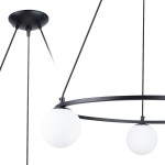 Lampa wisząca Yoli 3xG9 w kolorze czarnym, z metalową konstrukcją i trzema okrągłymi, matowymi kloszami w białym kolorze. Ujęcie z boku, pokazujące detale mocowania oraz kształt lampy. Wisi na trzech cienkich linkach.