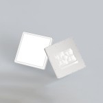 Plafon Aleria D23 w kolorze białym, o kwadratowym kształcie, z jedną diodą LED o mocy 22W. Widoczny jest tył lampy z miejscem na mocowanie oraz gładka, matowa powierzchnia przodu. Produkt leży na szarym tle.