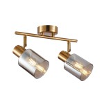 Lampa sufitowa Santia z dwoma reflektorami, wykonana z mosiądzu i dymionego szkła, montowana na metalowej belce. Reflektory mają cylindryczny kształt, z widocznymi żarówkami, ustawione pod kątem, na tle jednolitego, jasnego tła.