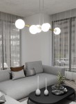 Lampa wisząca Gravity, 6-punktowa, z opalowymi kloszami, zamontowana na złotej, metalowej konstrukcji. Ujęcie frontalne, lampa wisi nad szarym narożnikiem w nowoczesnym wnętrzu, z dużymi oknami oraz minimalistycznymi dodatkami.