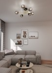 Lampa sufitowa Magnum, 6-punktowa, w kolorze czarnym, złotym i grafitowym. Zawiera sześć okrągłych, metalicznych kloszy, umieszczonych na złotych ramionach, montowana na suficie. Ujęcie z dołu, lampa w naświetlonym wnętrzu.