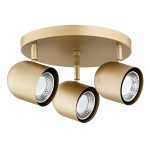 Lampa sufitowa Isola w kolorze złotym, z trzema reflektorami GU10. Reflektory mają cylindryczny kształt, z przezroczystą soczewką. Produkt montowany na okrągłej podstawie, z widocznymi elementami mocującymi.