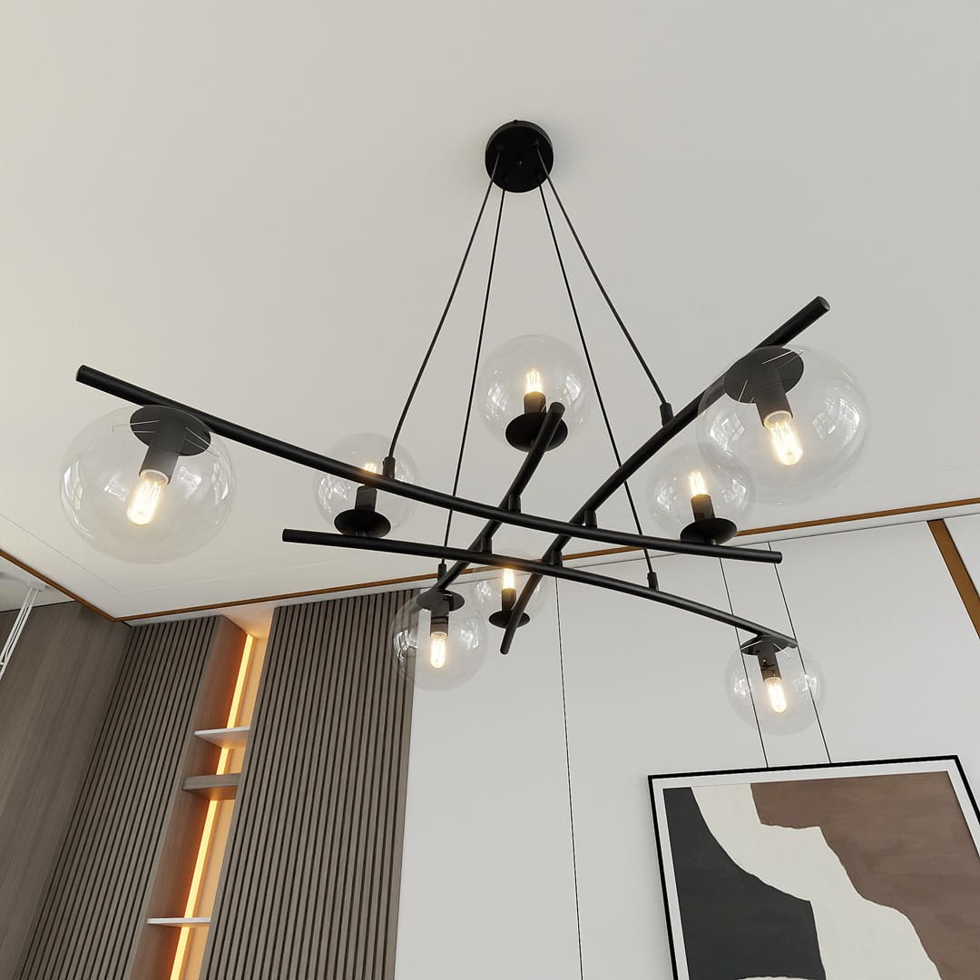 Lampa wisząca Essa 8-punktowa w kolorze czarnym i transparentnym z okrągłymi kloszami, zawieszona na cienkich linkach. Ułożona asymetrycznie na czarnych ramionach, z widocznymi żarówkami, w nowoczesnym wnętrzu z jasnym tłem.