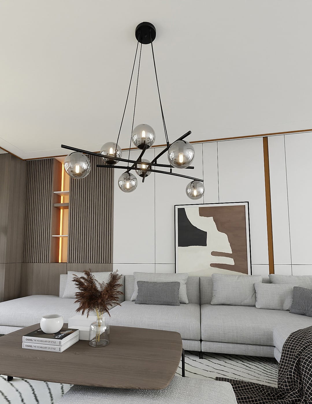 Lampa wisząca Essa 8-punktowa w kolorze czarnym i grafitowym, z okrągłymi, szklanymi kloszami. Ujęcie z góry, lampa zawieszona na cienkich linkach w nowoczesnym wnętrzu, nad szarym narożnikiem i drewnianym stolikiem.