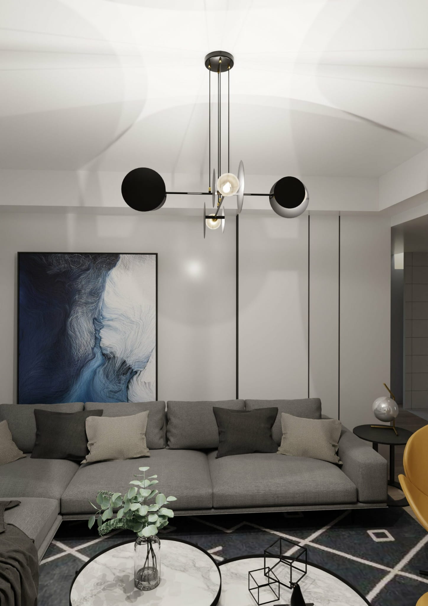 Lampa wisząca czarna 4-punktowa z metalowymi elementami, z okrągłymi kloszami w kolorze czarnym i białym. Ujęcie z góry, zawieszona nad szaro-beżową sofą w nowoczesnym wnętrzu, z obrazem na ścianie i stołem kawowym.