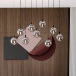 Lampa wisząca Cosmo 9-punktowa w kolorze grafitowym z okrągłymi, szklanymi kloszami. Zawieszona na cienkich linkach, w nowoczesnej aranżacji z tłem w odcieniach brązu i różu. Długość linki pozwala na różne ustawienia wysokości.