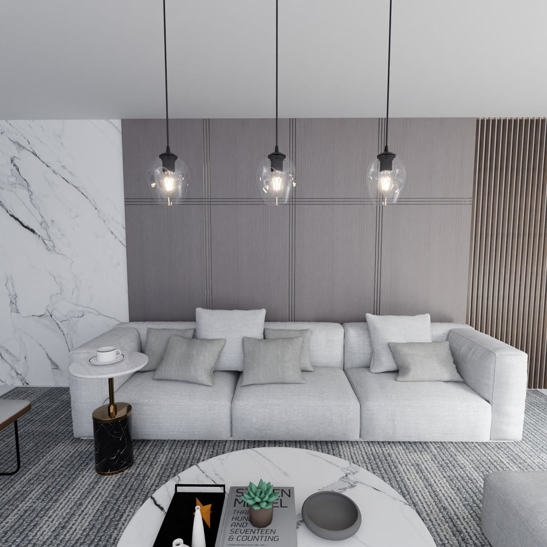 Lampa wisząca Istar 1-punktowa, transparentna, z okrągłym kloszem, zawieszona na czarnym przewodzie. W tle widoczna szara ściana oraz jasna sofa z poduszkami. Styl nowoczesny, pasujący do eleganckiego wnętrza.