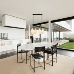 Lampa wisząca Istar 2-punktowa w kolorze miodowym, z podwójnymi kulistymi kloszami, zawieszona na czarnym stelażu. Widoczna w nowoczesnej aranżacji kuchennej nad okrągłym stołem, z czarnymi krzesłami w tle.