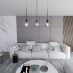 Lampa wisząca Istar mix 3-punktowa 678/3 z przezroczystymi kloszami w różnych odcieniach, zawieszona nad szarym, narożnym sofą z poduszkami. Elementy metalowe w kolorze czarnym i złotym, w nowoczesnym wnętrzu z marmurowym stołem i dekoracjami.