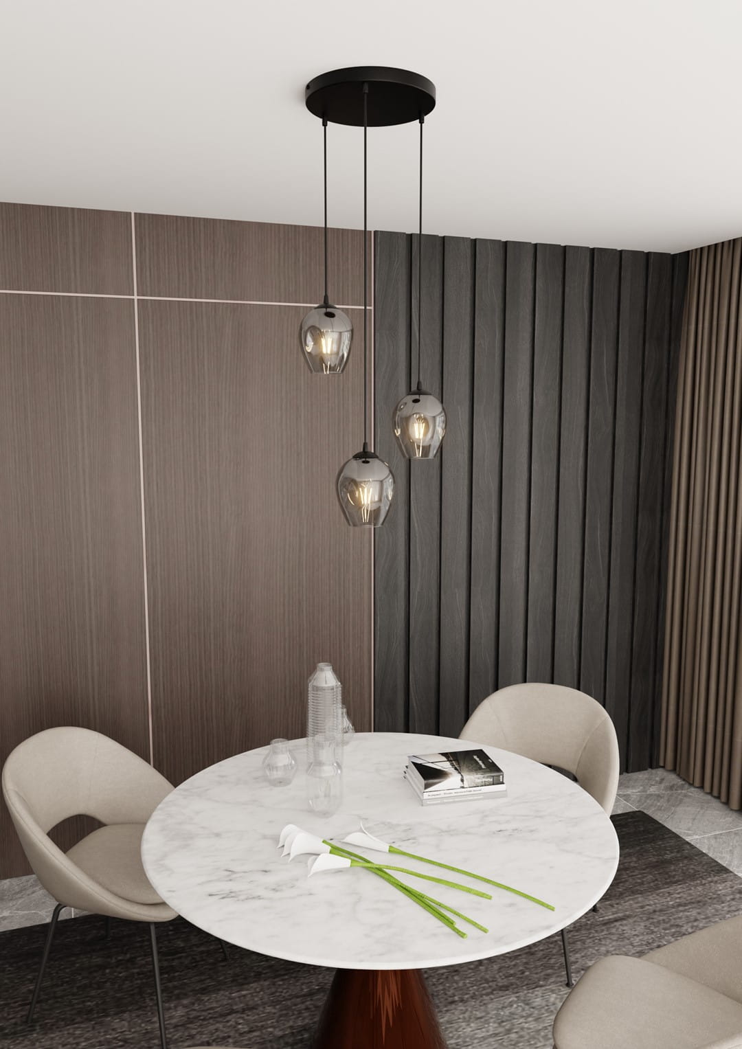 Lampa wisząca Istar Premium 3-punktowa w kolorze grafitowym, z trzema szklanymi kloszami o zaokrąglonym kształcie, zawieszona na czarnych linkach. Wisi nad okrągłym, marmurowym stołem w nowoczesnym wnętrzu.