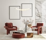 Lampa wisząca Ronza 1xLED/37W w kolorze złotym, z okrągłymi kloszami, zawieszona nad okrągłym stołem w stylowym wnętrzu. Tło stanowi gładka ściana oraz marmurowa dekoracja. Na stole wazon z gałązkami i dekoracje w odcieniach beżu i brązu.