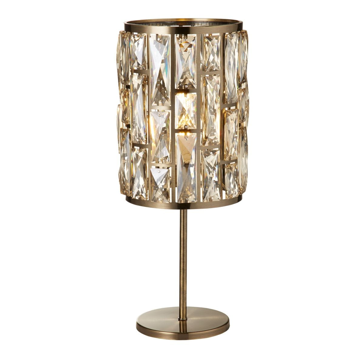 Lampa stołowa Bijou w antycznym mosiądzu z kloszem ozdobionym prostokątnymi kryształami. Ustawiona na okrągłej podstawie, z widocznym miejscem na żarówkę E14. Klosz ma cylindryczny kształt, prezentując elegancki design.