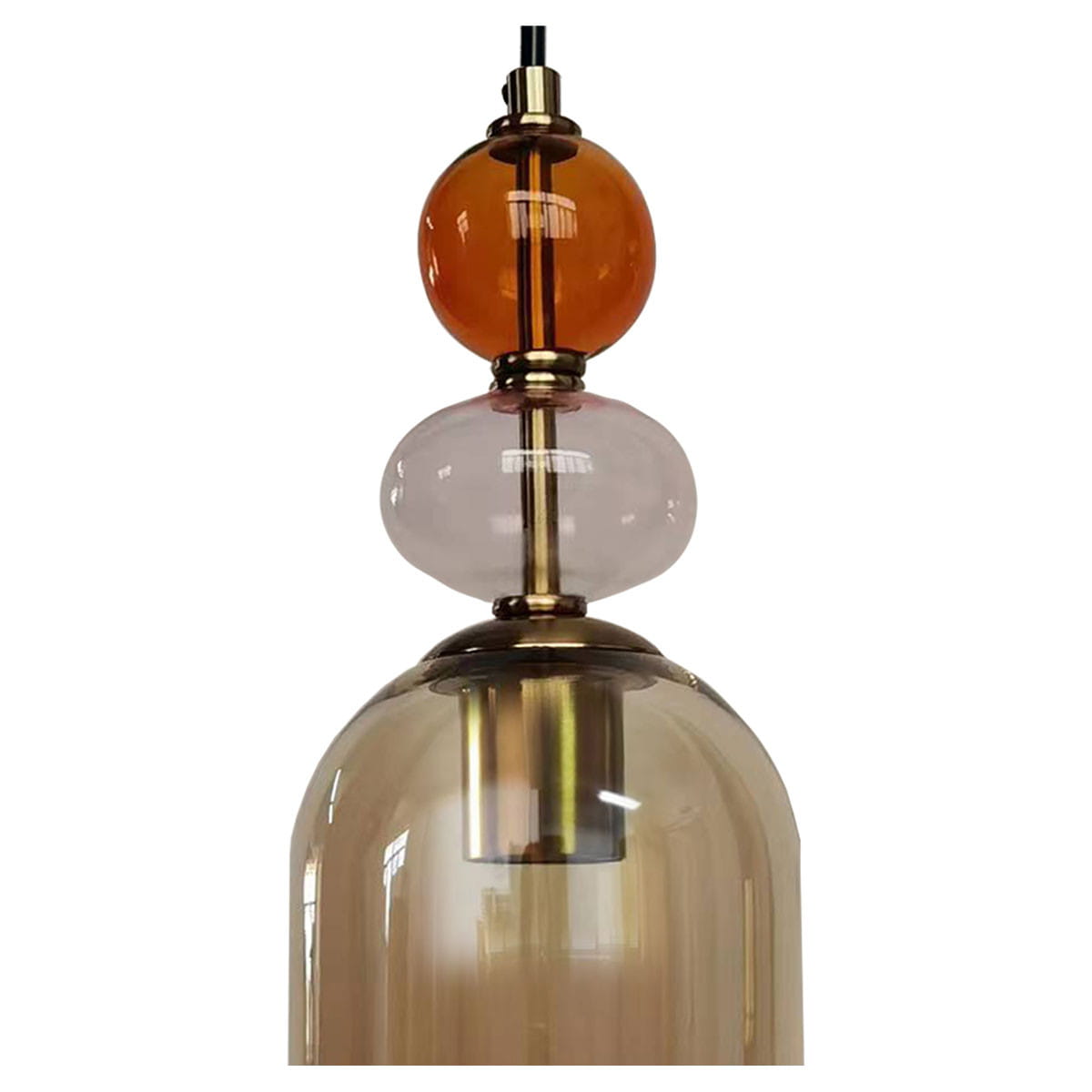 Lampa wisząca Tropea z jednym gniazdem E27, w kolorze czarnym i bursztynowym. Szklany klosz w kształcie dzwonu z widocznymi dekoracyjnymi kulami: bursztynową, różową i przezroczystą, zawieszona na cienkim przewodzie.