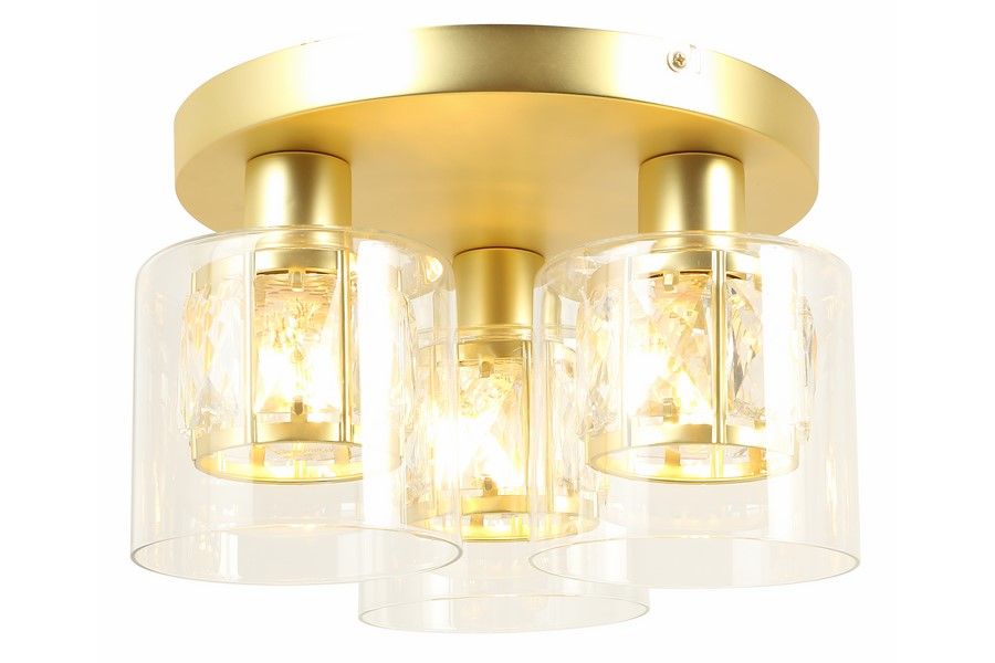 Lampa sufitowa Elmo z trzema źródłami światła E14, z metalowym złotym stelażem i przezroczystymi kloszami, w kształcie cylindrów. Ujęcie z boku, ukazujące detal wykończenia i efektowne oświetlenie.