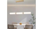 Lampa wisząca Catkin 3xLED/24W w kolorze złotym, z trzema mlecznymi kloszami w kształcie cylindrów. Zawieszona nad białym stołem w jasnym wnętrzu, z drewnianymi krzesłami i rośliną w tle. Kąt ujęcia frontalny, prezentujący całość oświetlenia.
