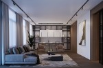 Lampa wisząca Pastelo 1xG9 w kolorze czarnym, zamontowana na szynie 3F. Wnętrze w stylu nowoczesnym z widocznymi detalami, takimi jak dwa wygodne fotele, stół kawowy oraz regał w tle. Oświetlenie umieszczone nad strefą wypoczynkową.